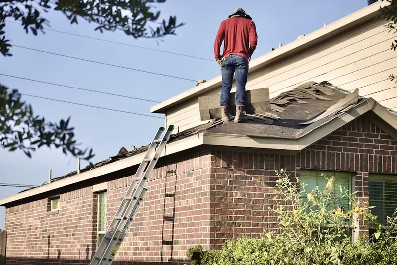 Professional roofer working on a residential roof in Larose
